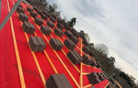Experienced roofers installing traditional slate tiles on a new Tyneside roof